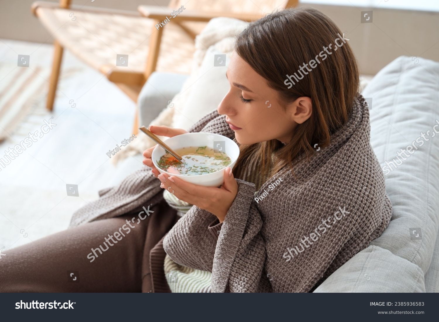 Ill young woman eating chicken soup at home, closeup #2385936583