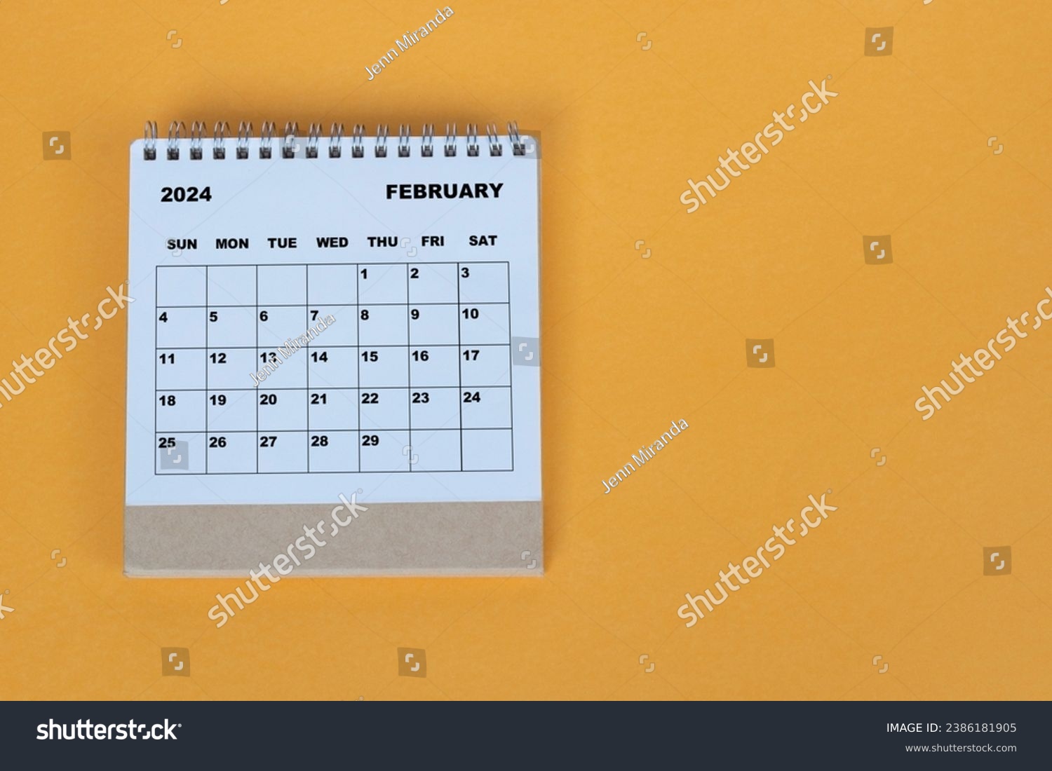 February 2024 desk calendar on yellow background. Directly above. Flat lay. #2386181905