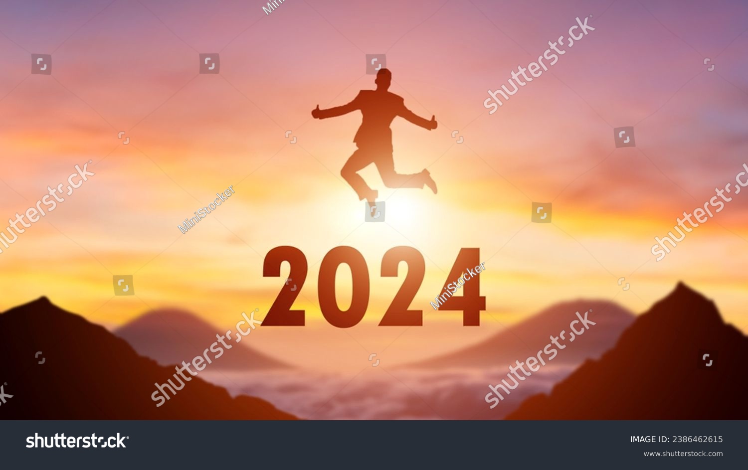 Silhouette of a person leaping from 2023 to 2024 on the top of the mountain background. Happy New Year and Christmas day concept. #2386462615