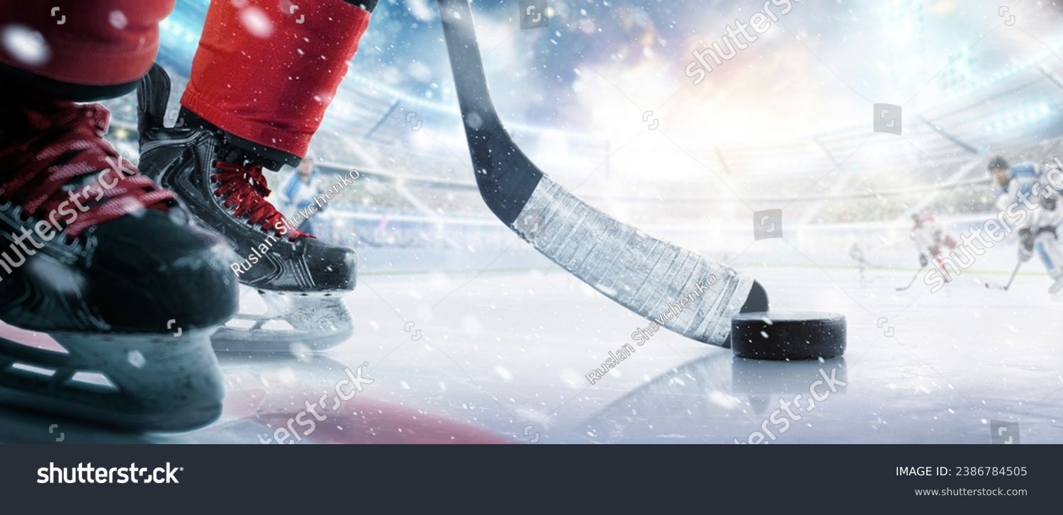 Hockey puck and stick close-up. Hockey player in ice arena. Focus on the puck. Hockey concept. Ice. Hockey stadium #2386784505