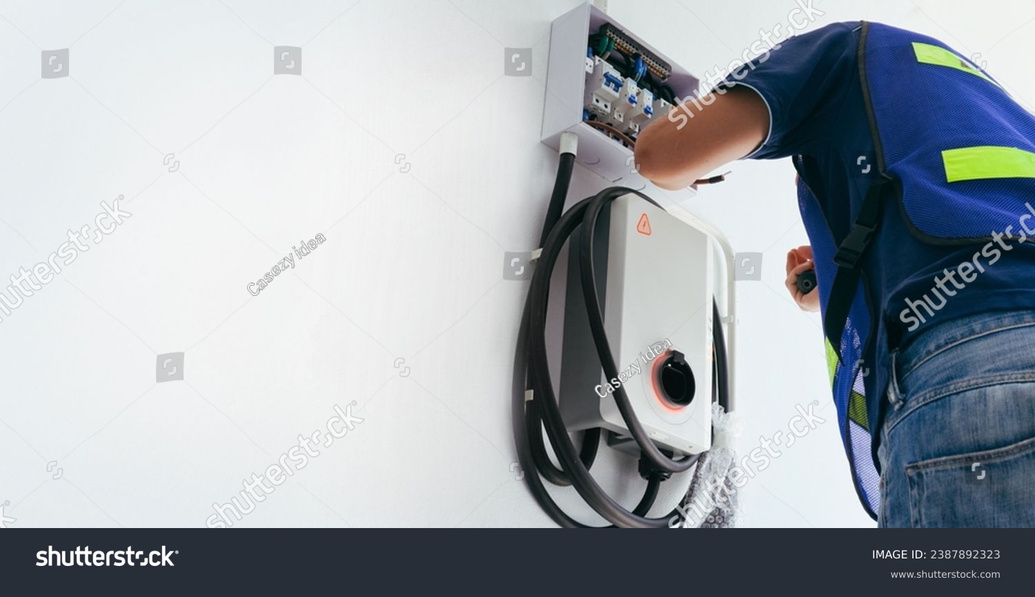 Certified male Electrician Installing Home EV Charger #2387892323
