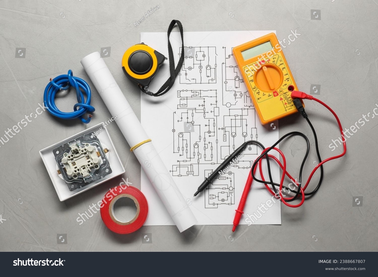 Wiring diagram, wires and digital multimeter on light grey table, flat lay #2388667807