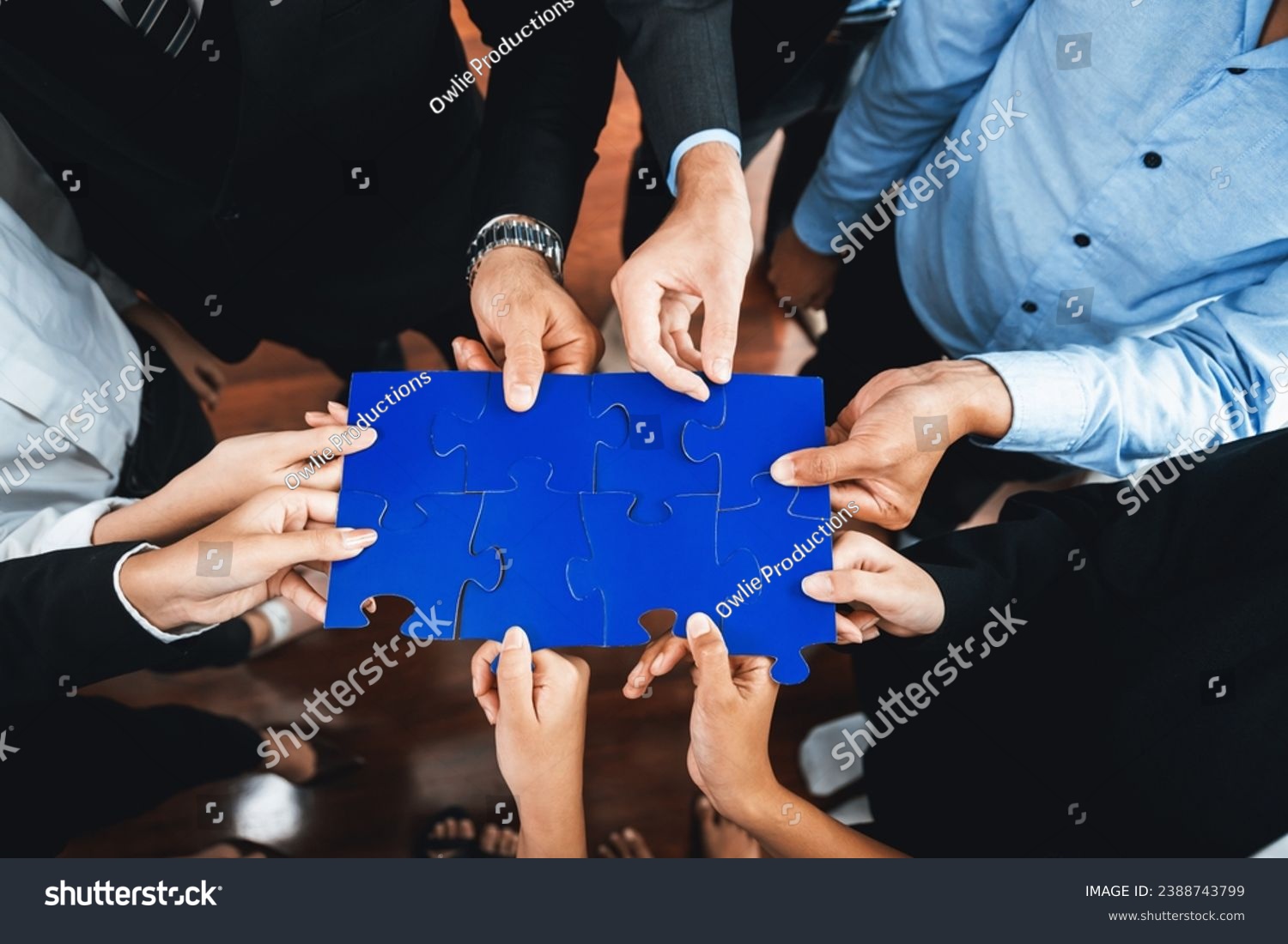 Top view multiethnic business people holding jigsaw pieces and merge them together as effective solution solving teamwork, shared vision and common goal combining diverse talent. Meticulous #2388743799