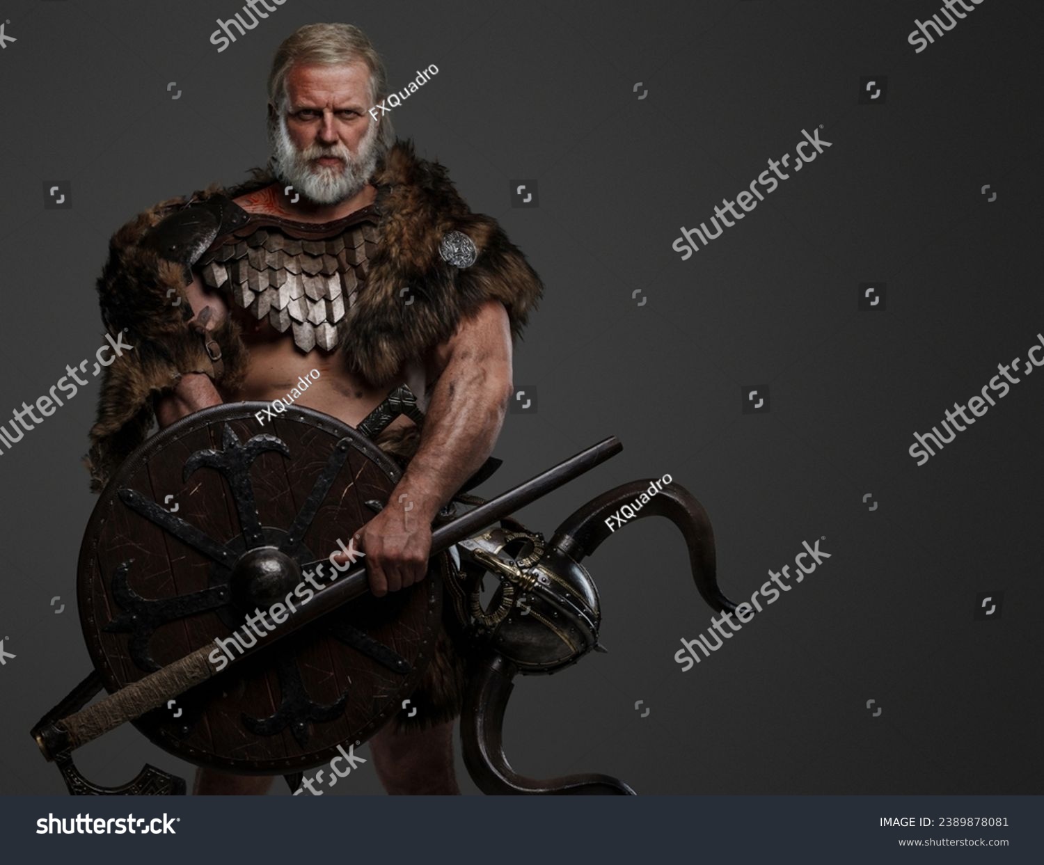 A rugged, silver-haired, bearded elderly viking dressed in fur and lightweight armor, with a helmet attached to his belt, holding an axe and shield against a gray background #2389878081