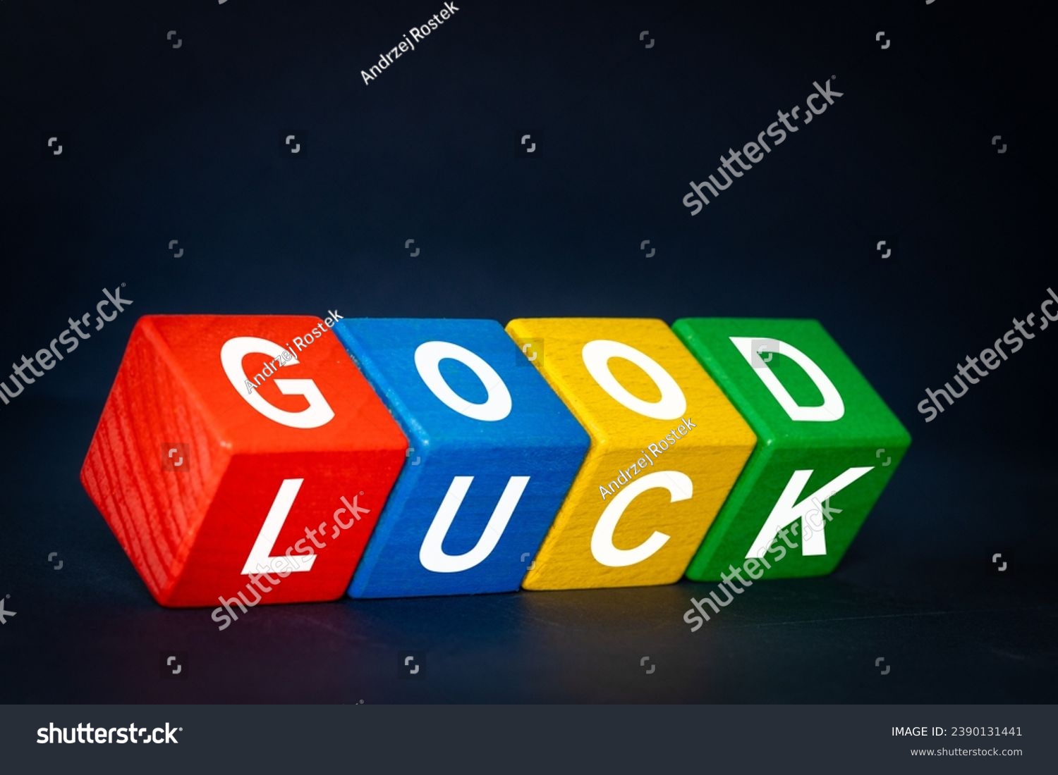 Good Luck symbol. Positive multicolored wooden blocs with the words Good Luck. Beautiful navy blue background, business and good luck concept. Copy space #2390131441
