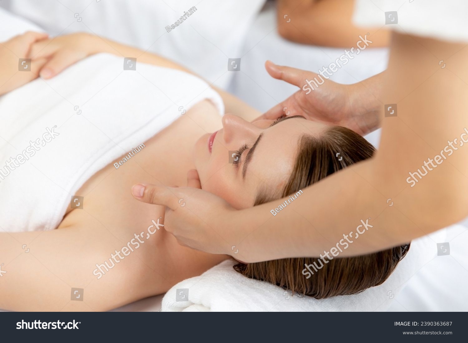 Caucasian woman enjoying relaxing anti-stress head massage and pampering facial beauty skin recreation leisure in dayspa modern light ambient at luxury resort or hotel spa salon. Quiescent #2390363687