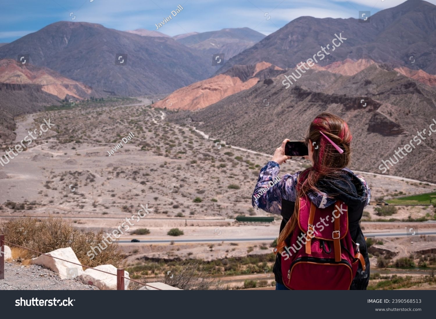Tourist taking photos of the beautiful mountains in Tilcara, Jujuy, Argentina. Vacation person taking photos. Beautiful landscape of northern Argentina #2390568513