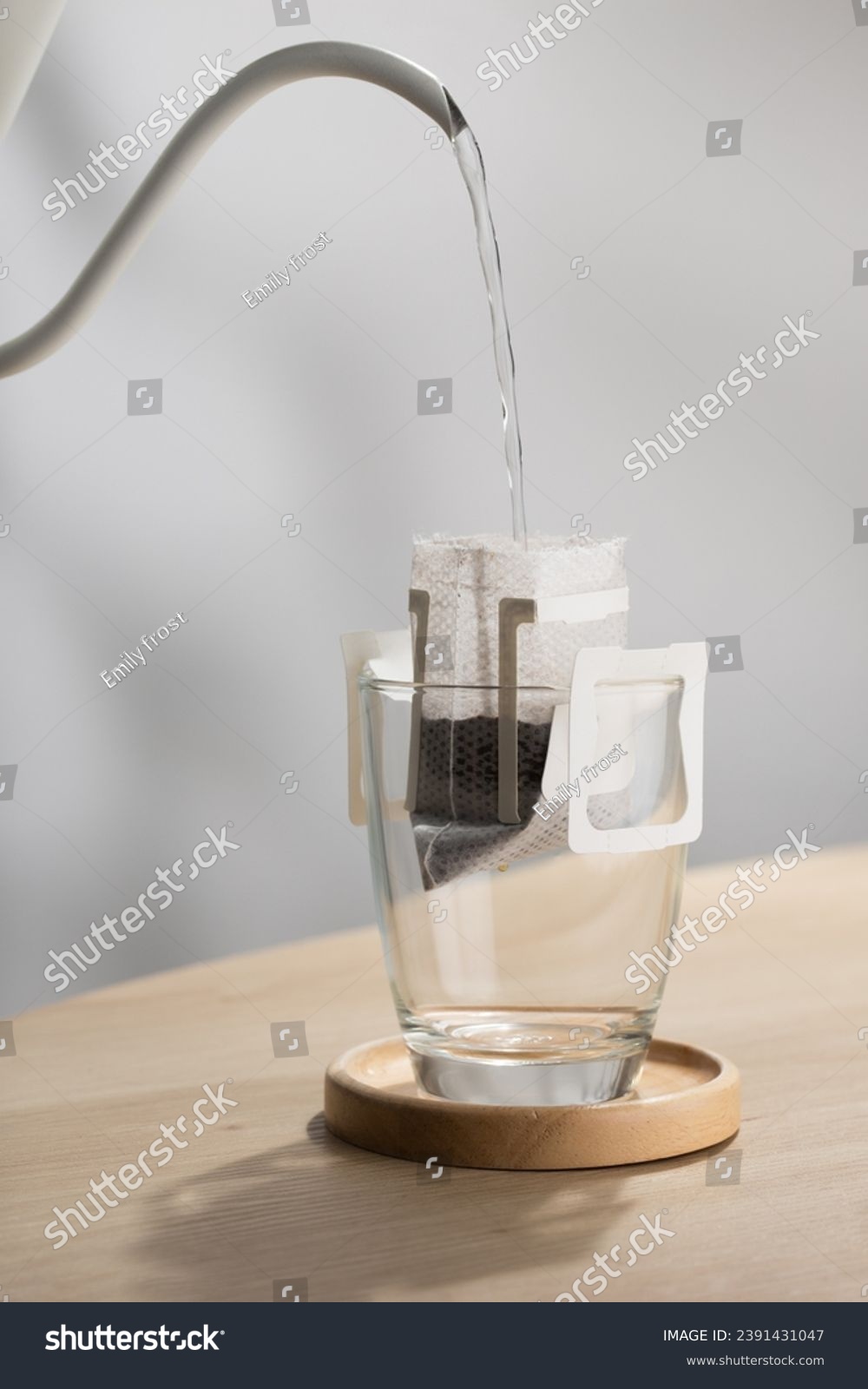 The hot water is poured over the roasted and ground coffee, in a filter paper ready to use. #2391431047
