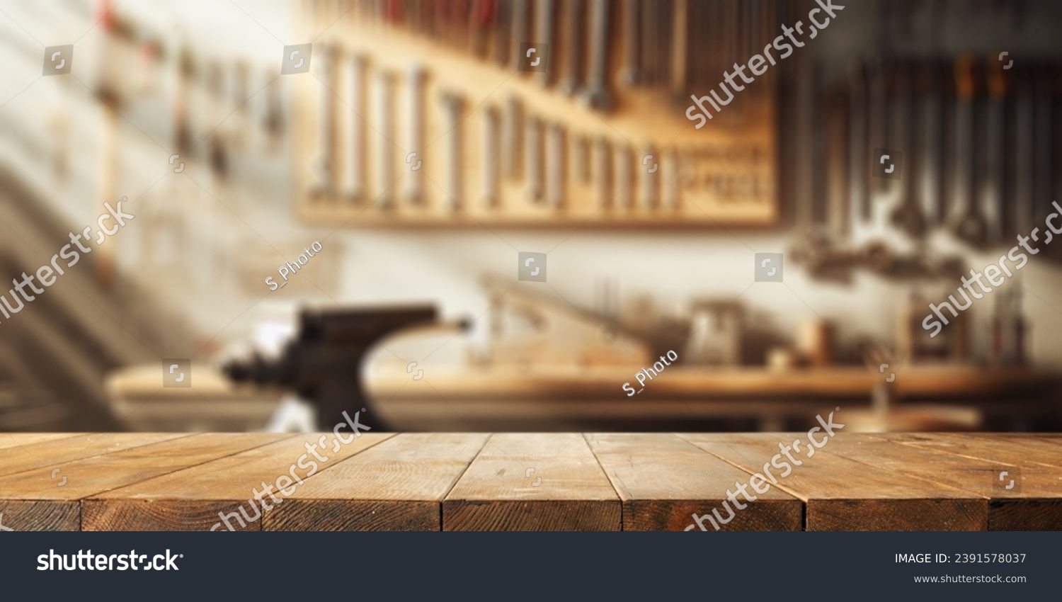Worn old wooden table and workshop interior. Retro vintage photo of background and mockup. Sun light and dark shadows.  #2391578037