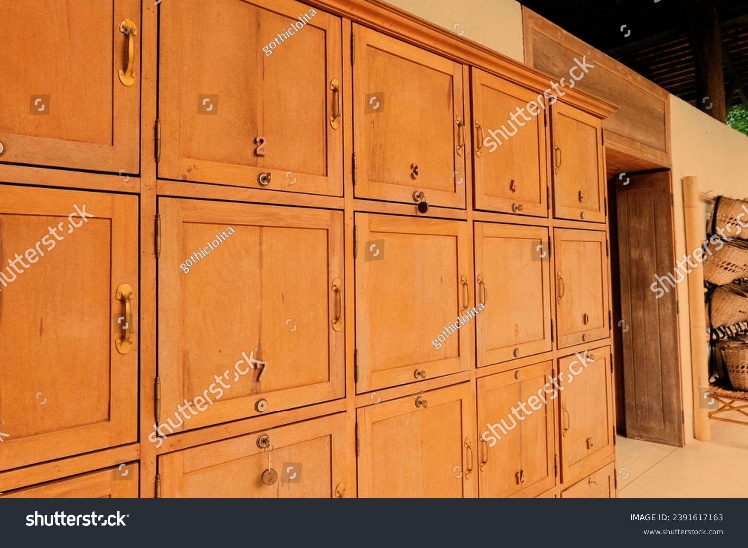 Wooden lockers in a locker room in the modern building, Locker room interior in modern fitness gym, free text space and empty room. #2391617163