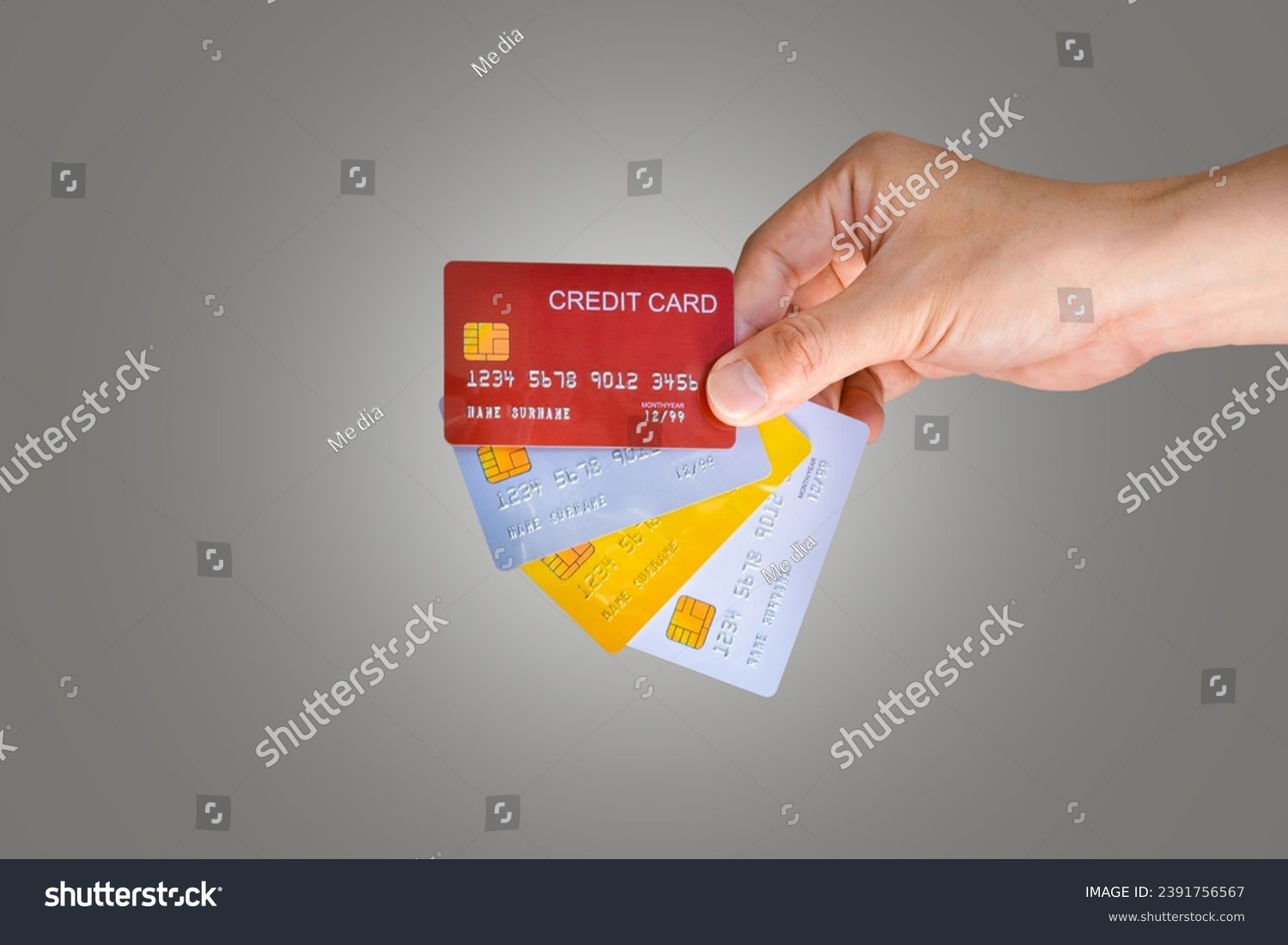 Man holding several credit cards and he use credit card to pay and spend Payment for goods via credit card . Finance and banking concept. #2391756567