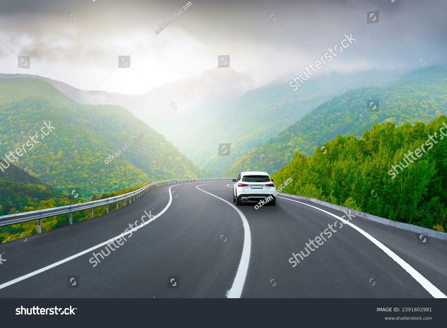 white car drive on mountain road landscape in winter. Nature scenery on highway in green mountains. Winter travel on black asphalt road. Car driving in the beautiful nature of Europe. Bavaria, Germany #2391802981