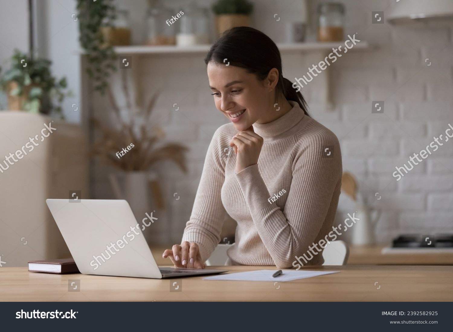 Smiling pretty woman searching information on internet, working or studying, busy in self-education, ordering goods or food on-line using laptop. E-commerce client, modern wireless tech usage concept #2392582925