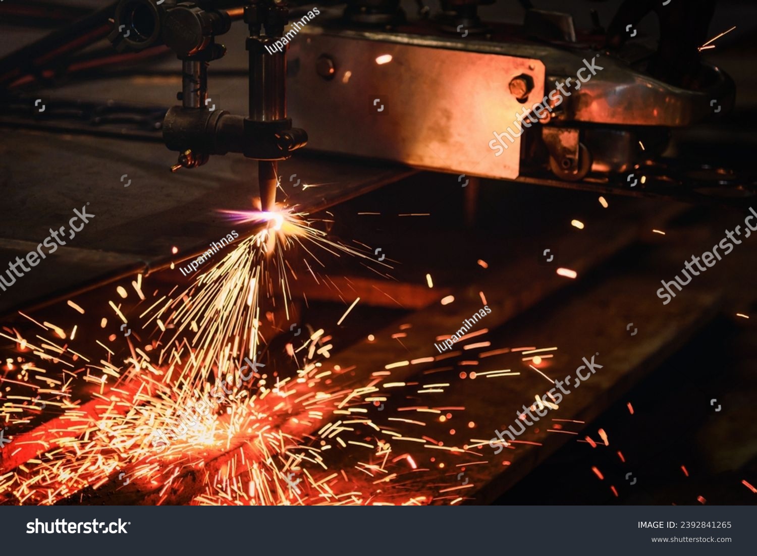 Worker cutting steel plate with acetylene welding cutting torch and bright sparks in steel industry. #2392841265