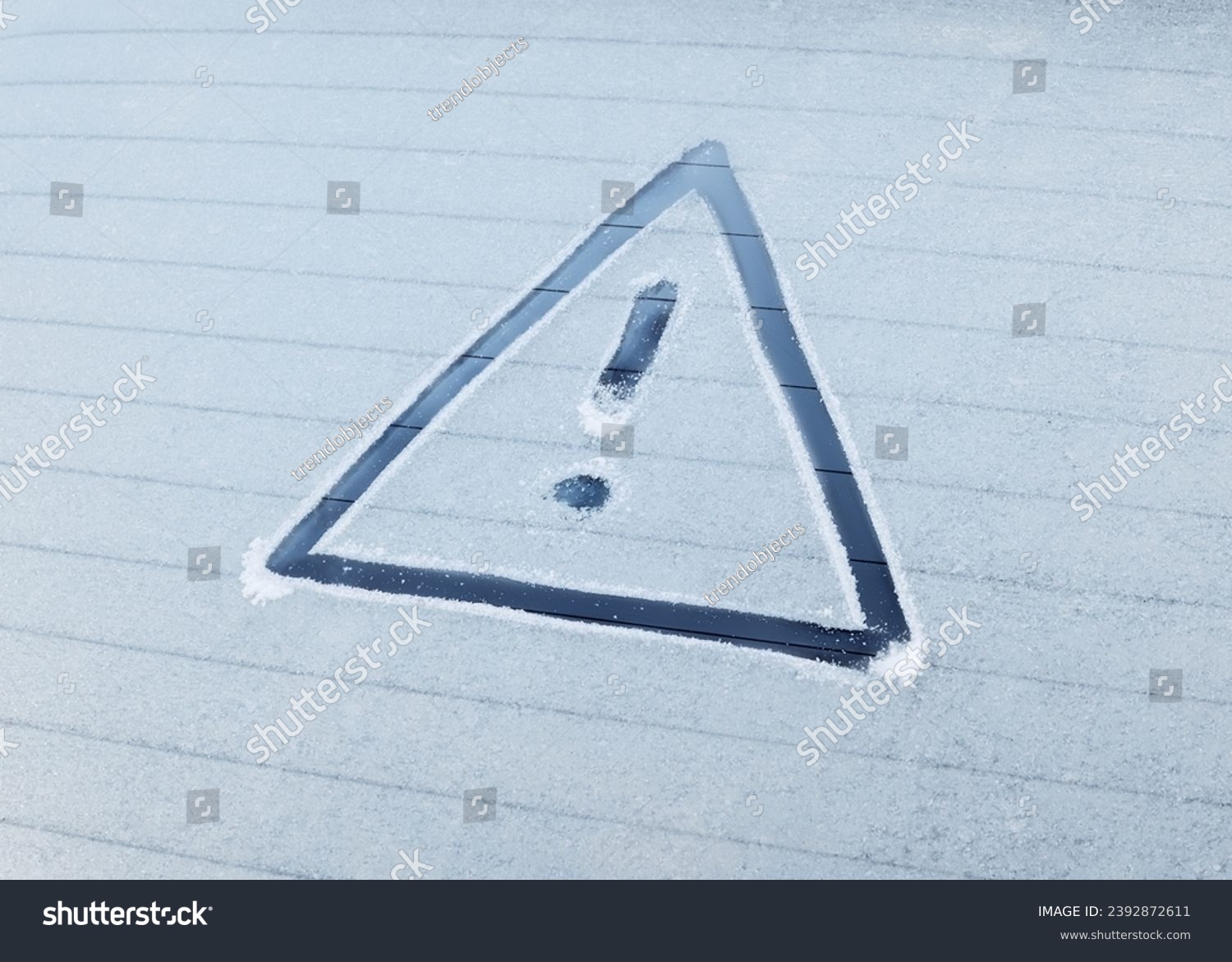 Winter Driving - Caution!

A warning triangle drawn in the ice on a frozen rear window of a car. #2392872611