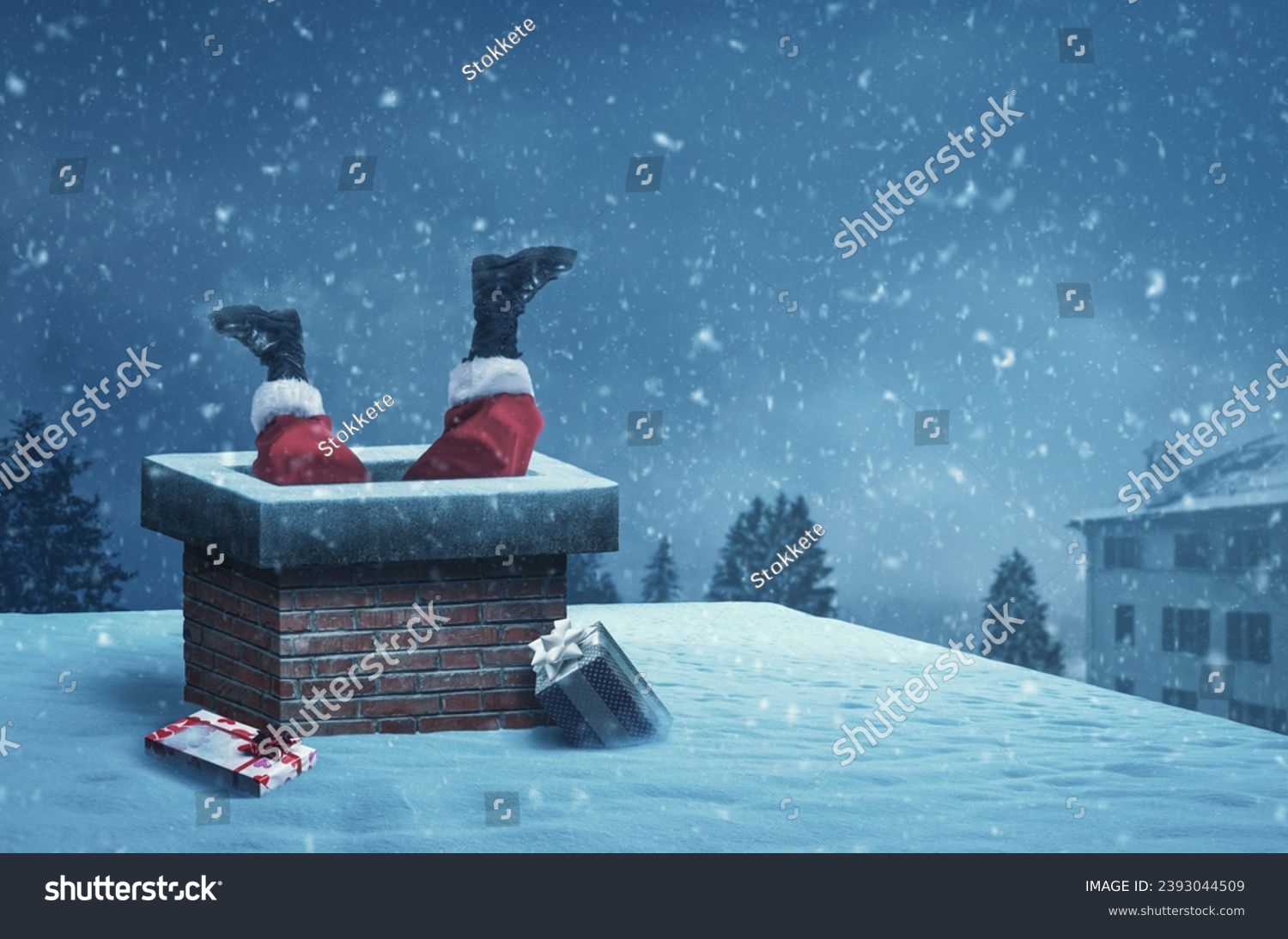 Funny Santa Claus stuck with feet up in a chimney on a roof, he is delivering gifts on Christmas Eve #2393044509