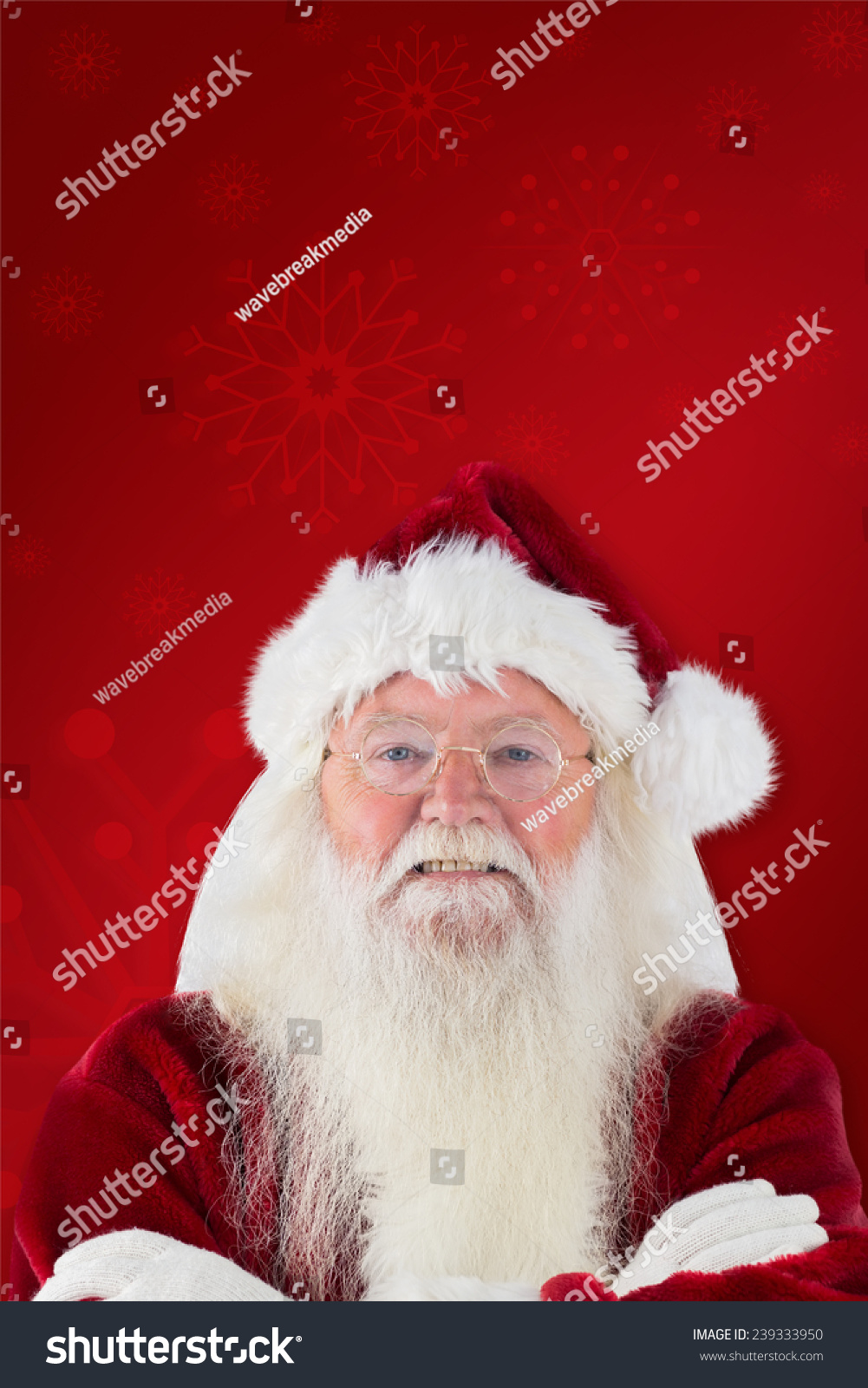 Santa smiles with folded arms against red background #239333950