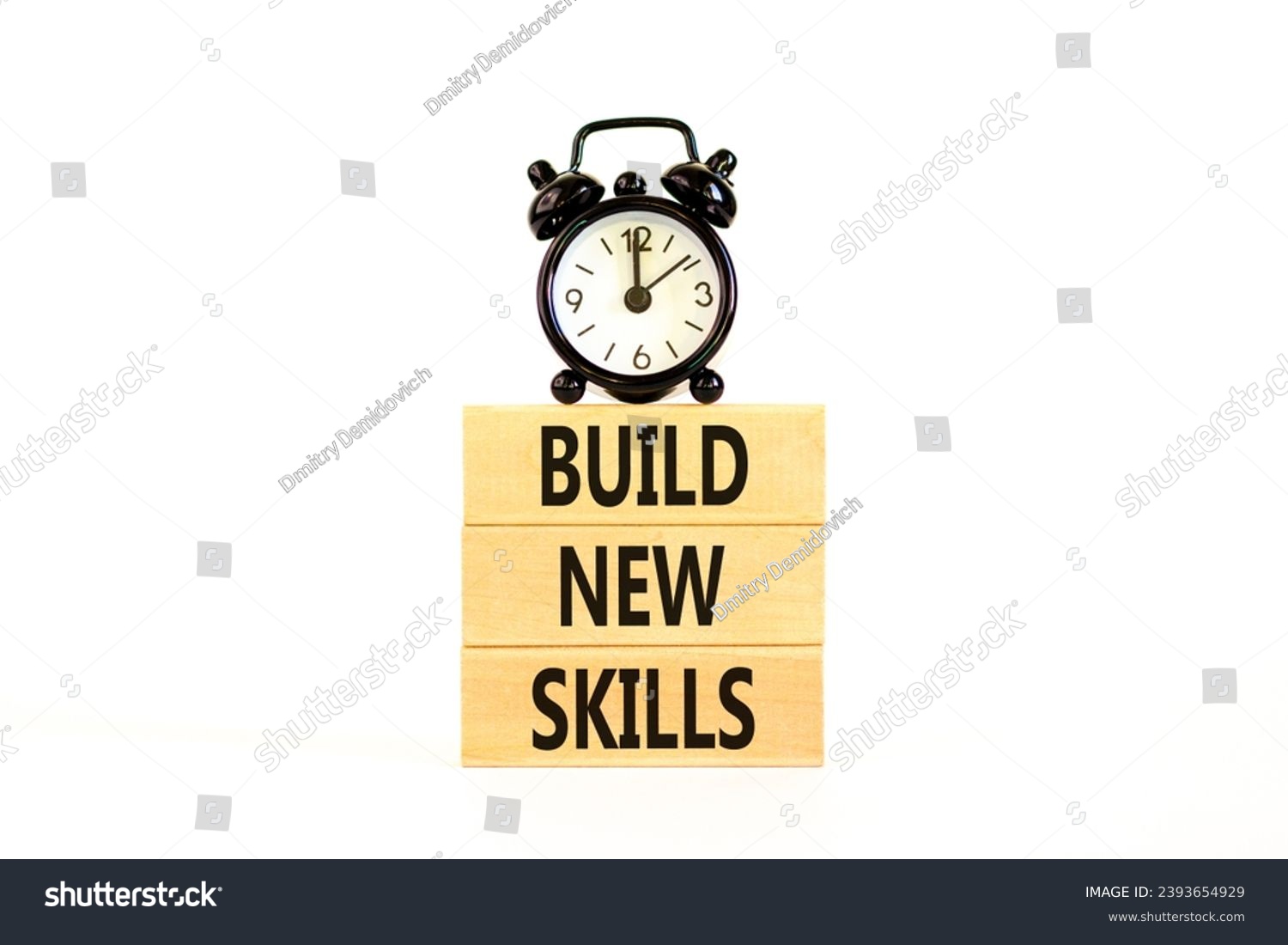 Build new skills symbol. Concept word Build new skills on beautiful wooden block. Black alarm clock. Beautiful white table white background. Business, education build new skills concept. Copy space. #2393654929
