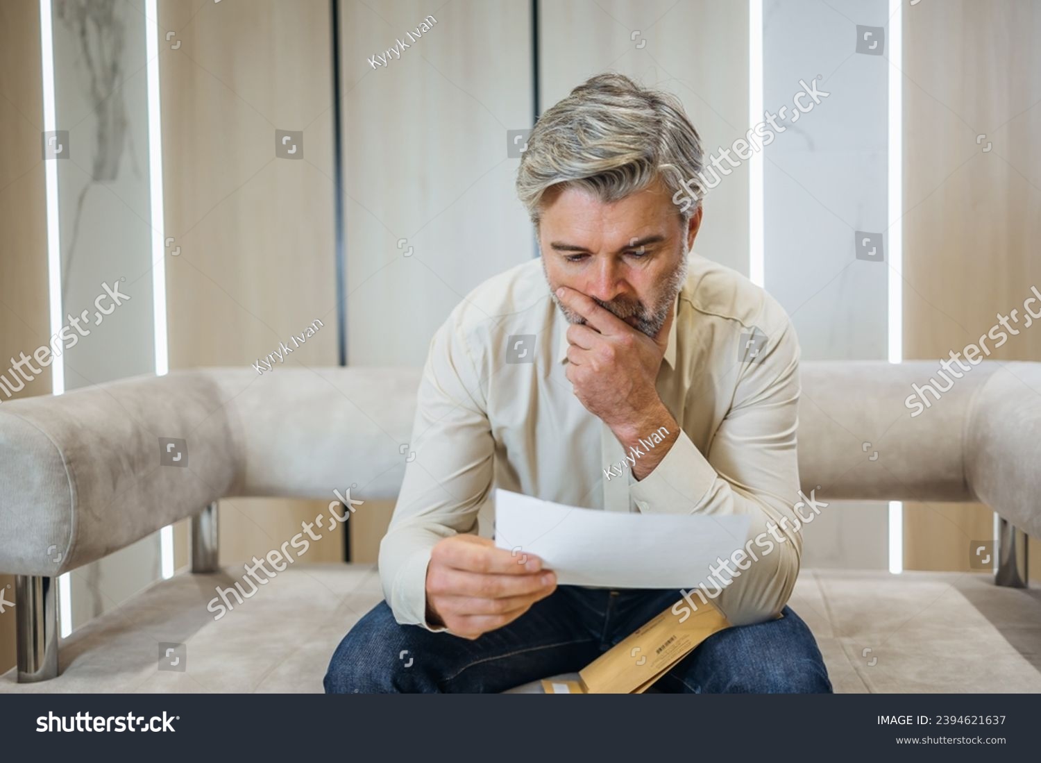 stressed businessman opening envelope reading bad news in mail letter. Mad man feels frustrated about high bills, dismissal notice, bank debt, tax invoice or mistake #2394621637