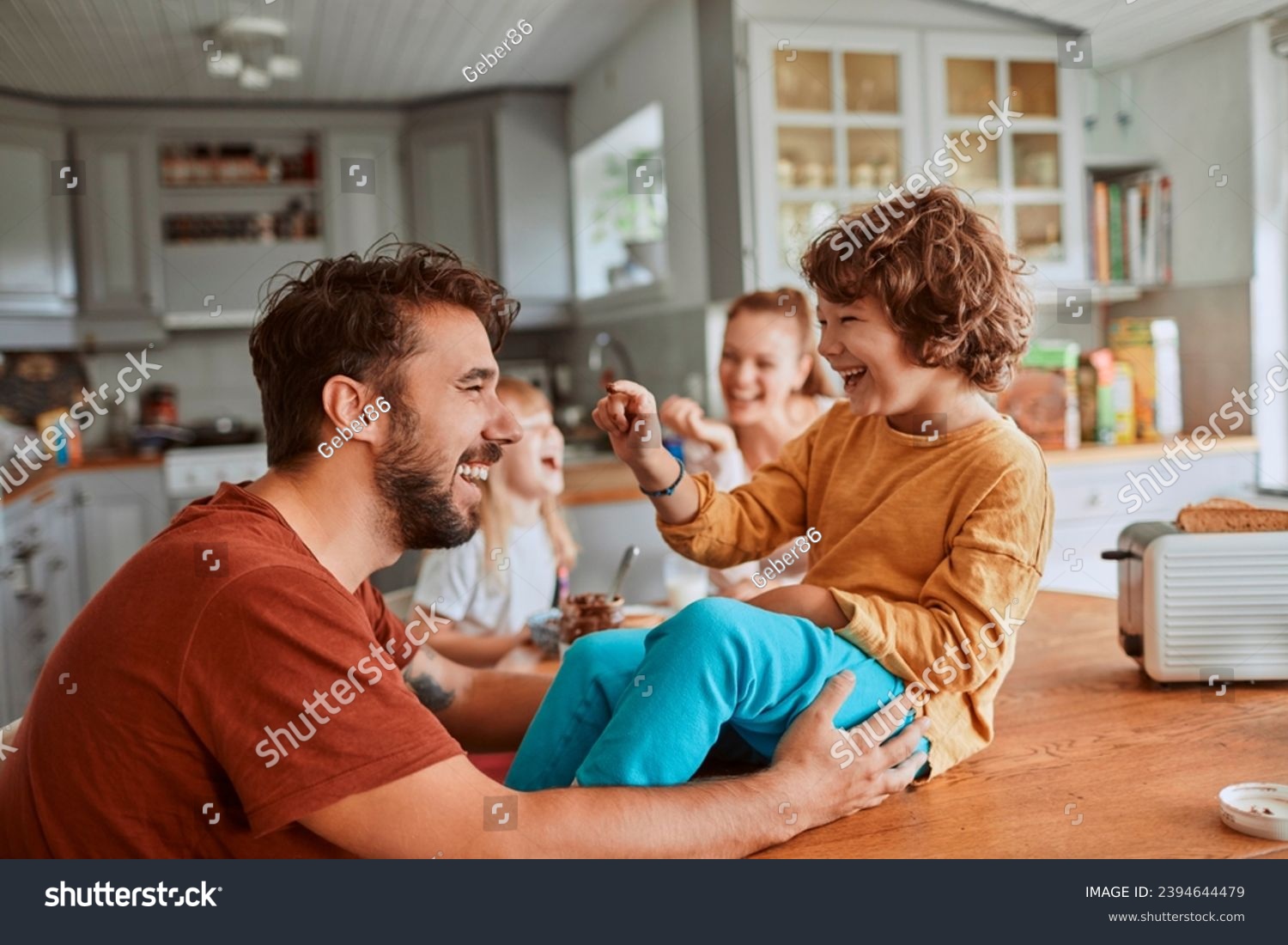 Cheerful family has fun during a meal at the dining table #2394644479