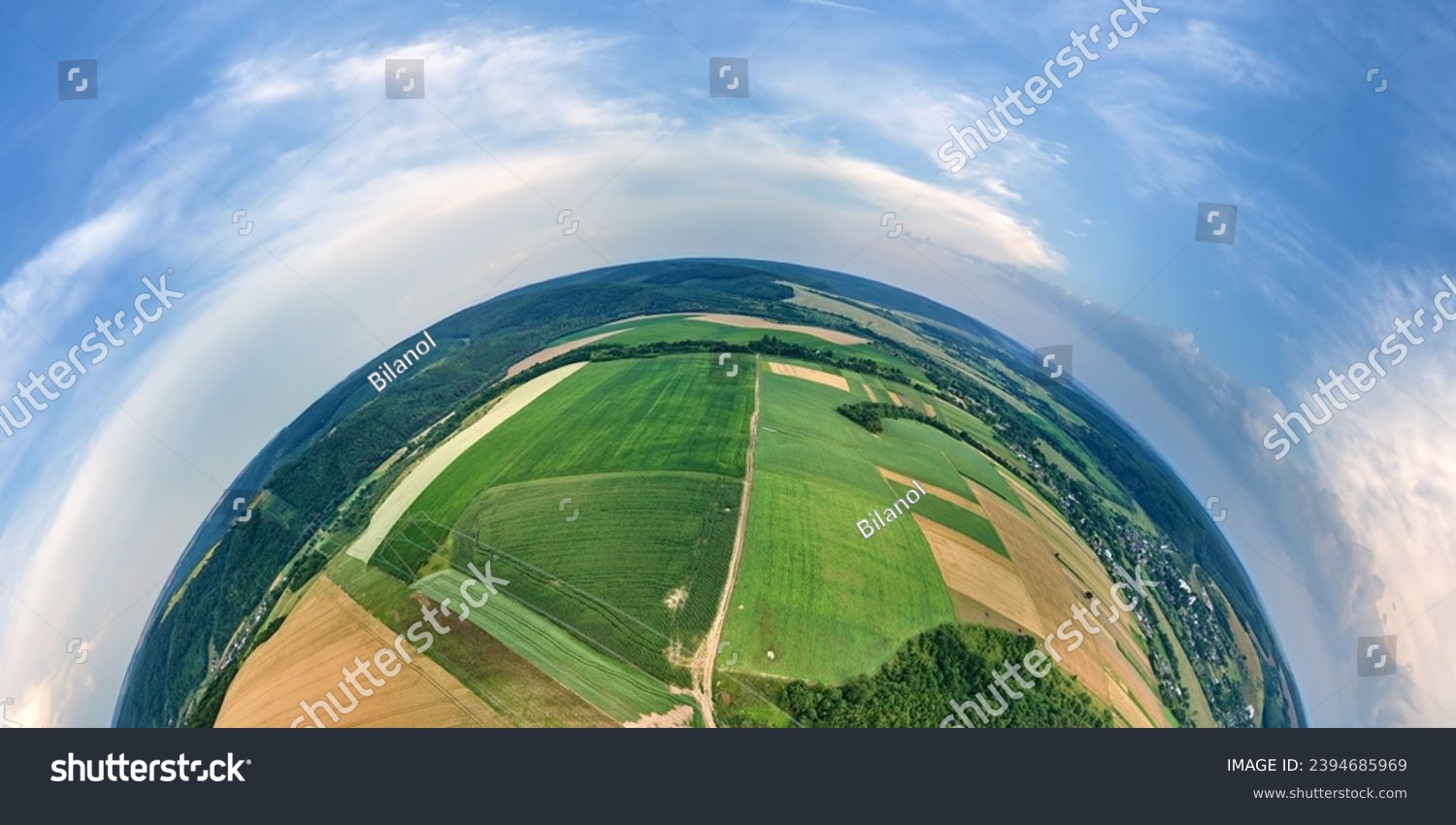 Aerial view from high altitude of little planet earth with green and yellow cultivated agricultural fields with growing crops on bright summer day #2394685969