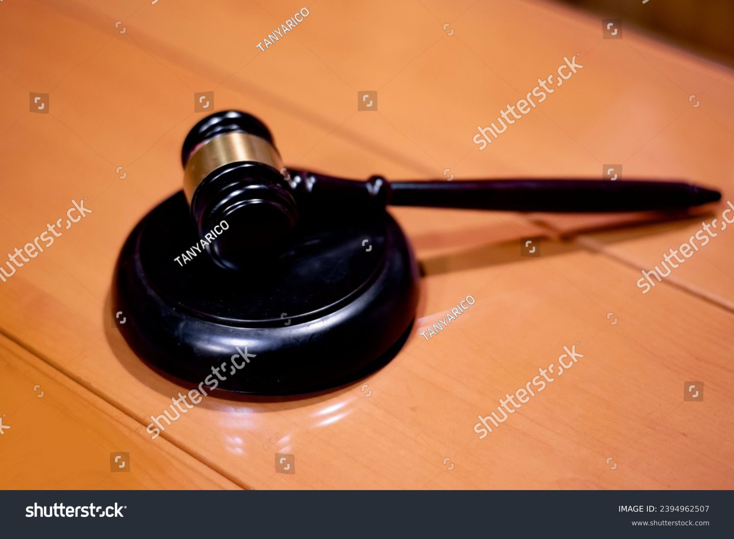 Judicial gavel HAMMER years on a backing on a wooden table, close-up, selective focus #2394962507