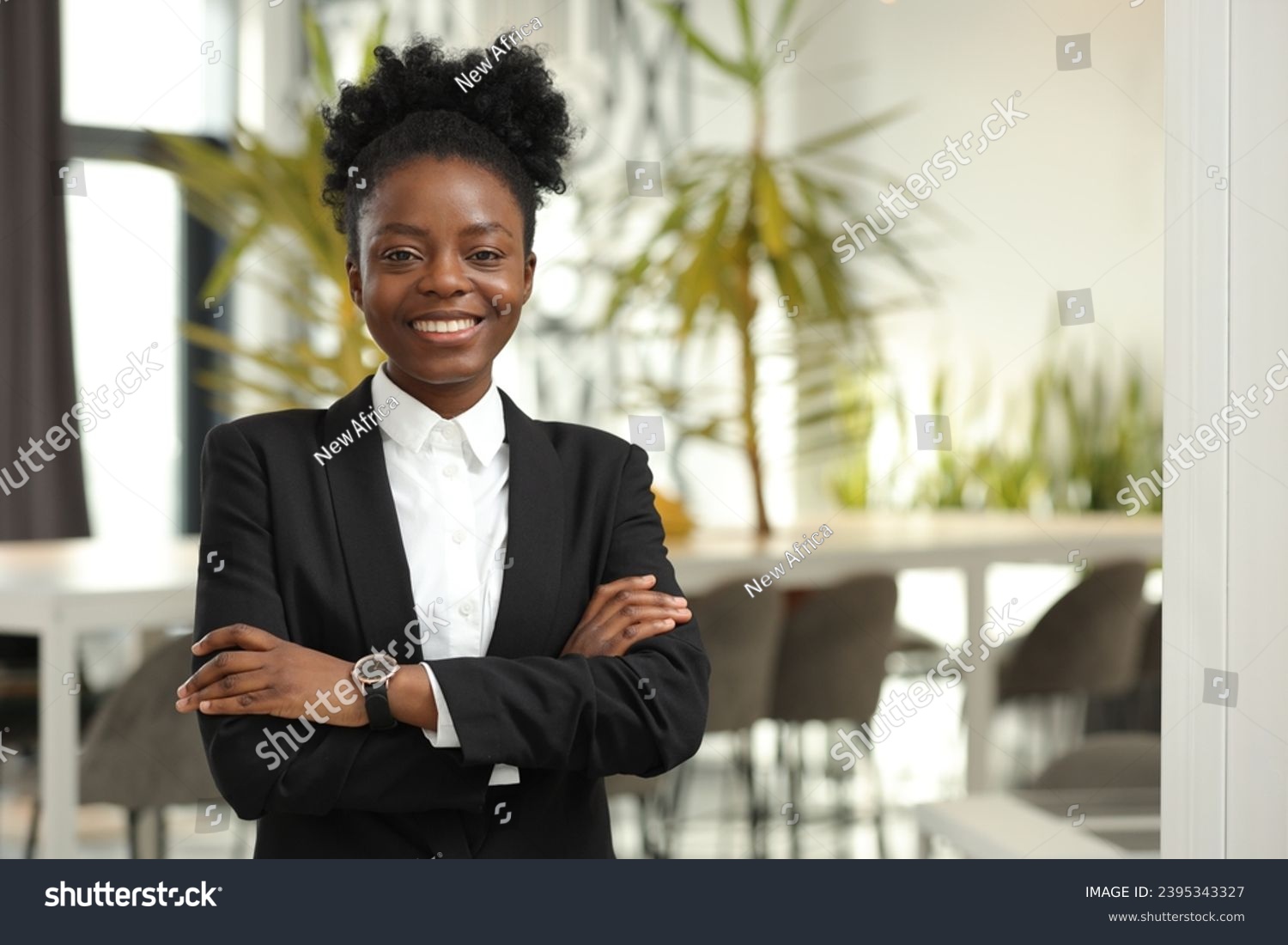 Happy woman with crossed arms in office, space for text. Lawyer, businesswoman, accountant or manager #2395343327