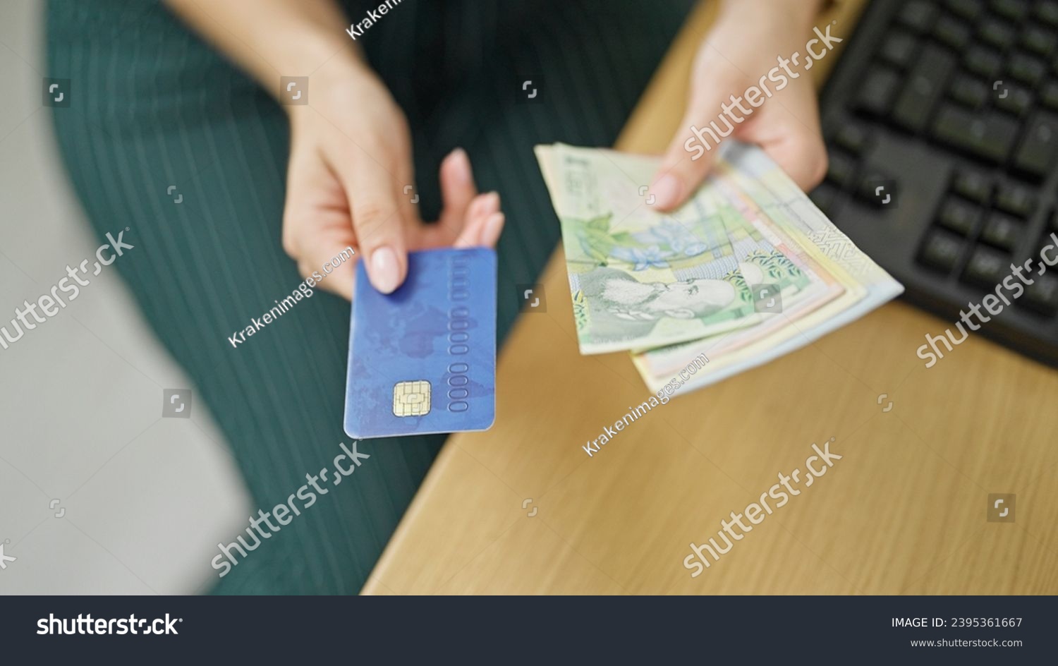 Young redhead woman business worker holding romanian leu banknotes and credit card at office #2395361667