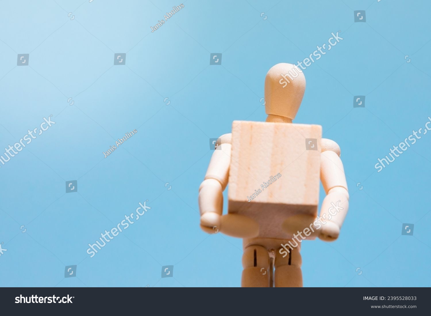 Manual handling at work. Wooden manikin holding a box. Handling technique. Health and safety at work. #2395528033