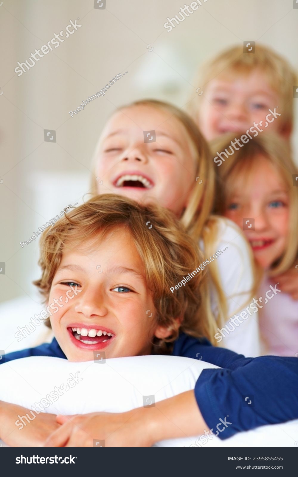 Portrait, love or laughing with brother and sister sibling children on a bed in the home together. Family, happy or bonding with funny boy and girl kids in the bedroom of an apartment on the weekend #2395855455