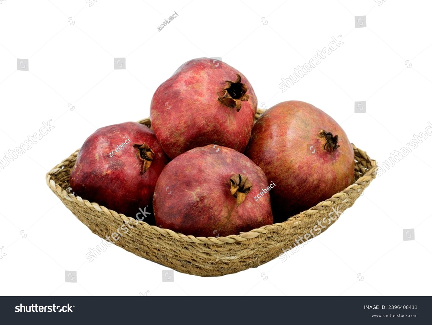 Four pomes of the pomegranate (Punica granatum) in a basket plate #2396408411