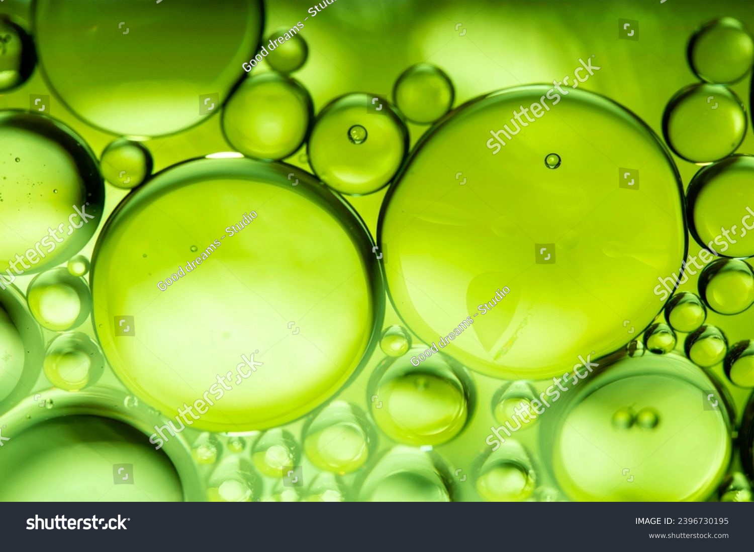 lemon drops of oil or serum texture background. Abstract lemon fluid with bubbles #2396730195