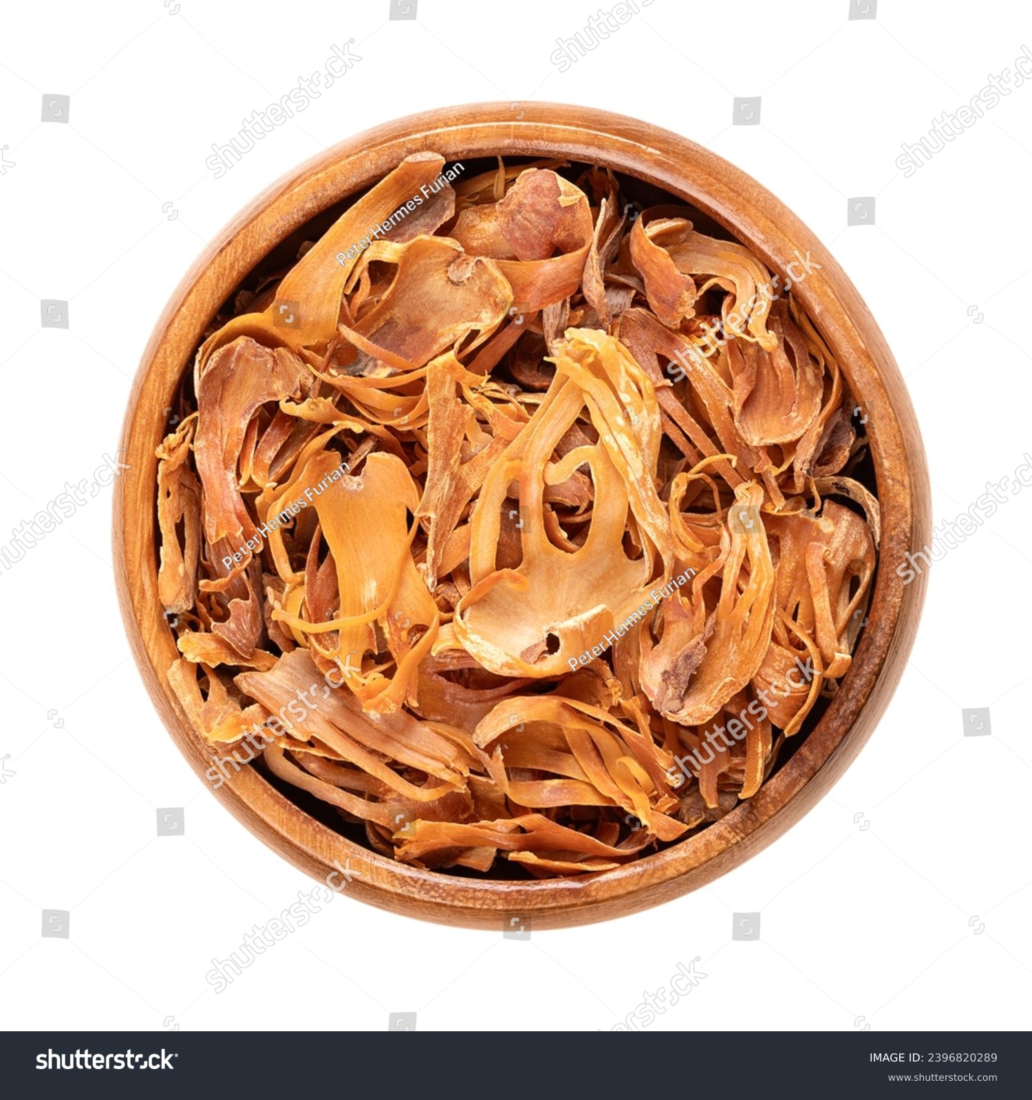 Dried mace in a wooden bowl. Spice with pale yellow and orange tan, made of seed coverings of nutmeg seeds, with similar flavor, but more delicate. Used to flavor food and in preserving and pickeling. #2396820289