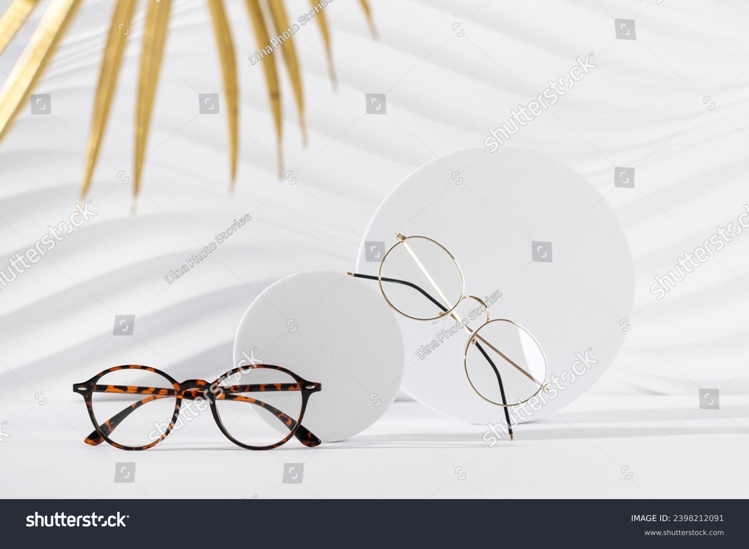 Two pairs of eyeglass frames on white background. Minimalism, eyewear fashion concept. Trendy eyeglasses still life in minimal style. Optic store discount, sale, promotion. Copy space #2398212091