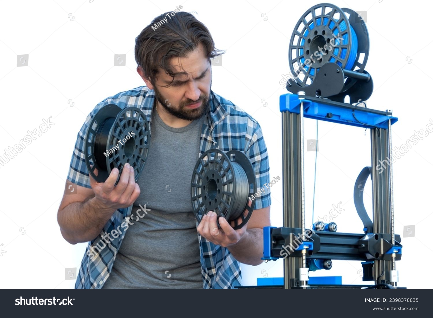 Man selecting filaments to make a 3D print. #2398378835