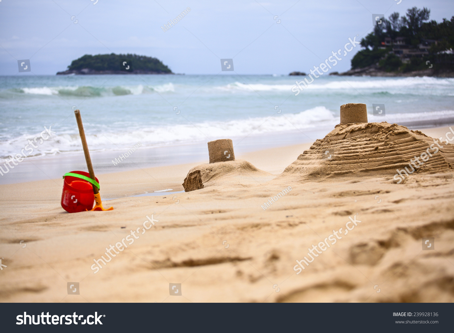 Sand castles made by children on the background of the sea #239928136