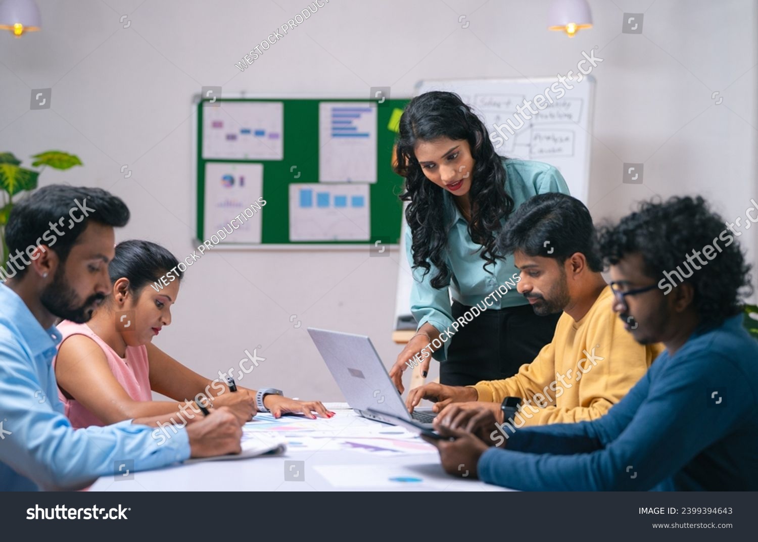 Team of co-workers busy working at office during discussion or business training - concept of communication, startup coordination and woman leadership. #2399394643