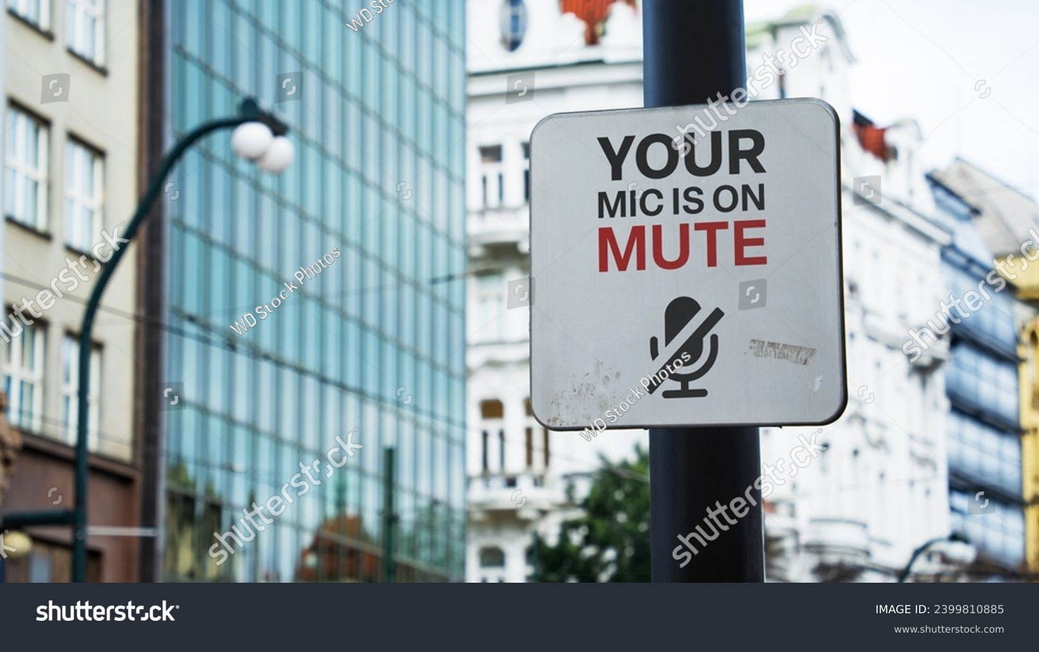 Your mic is on mute sign in a city business district #2399810885