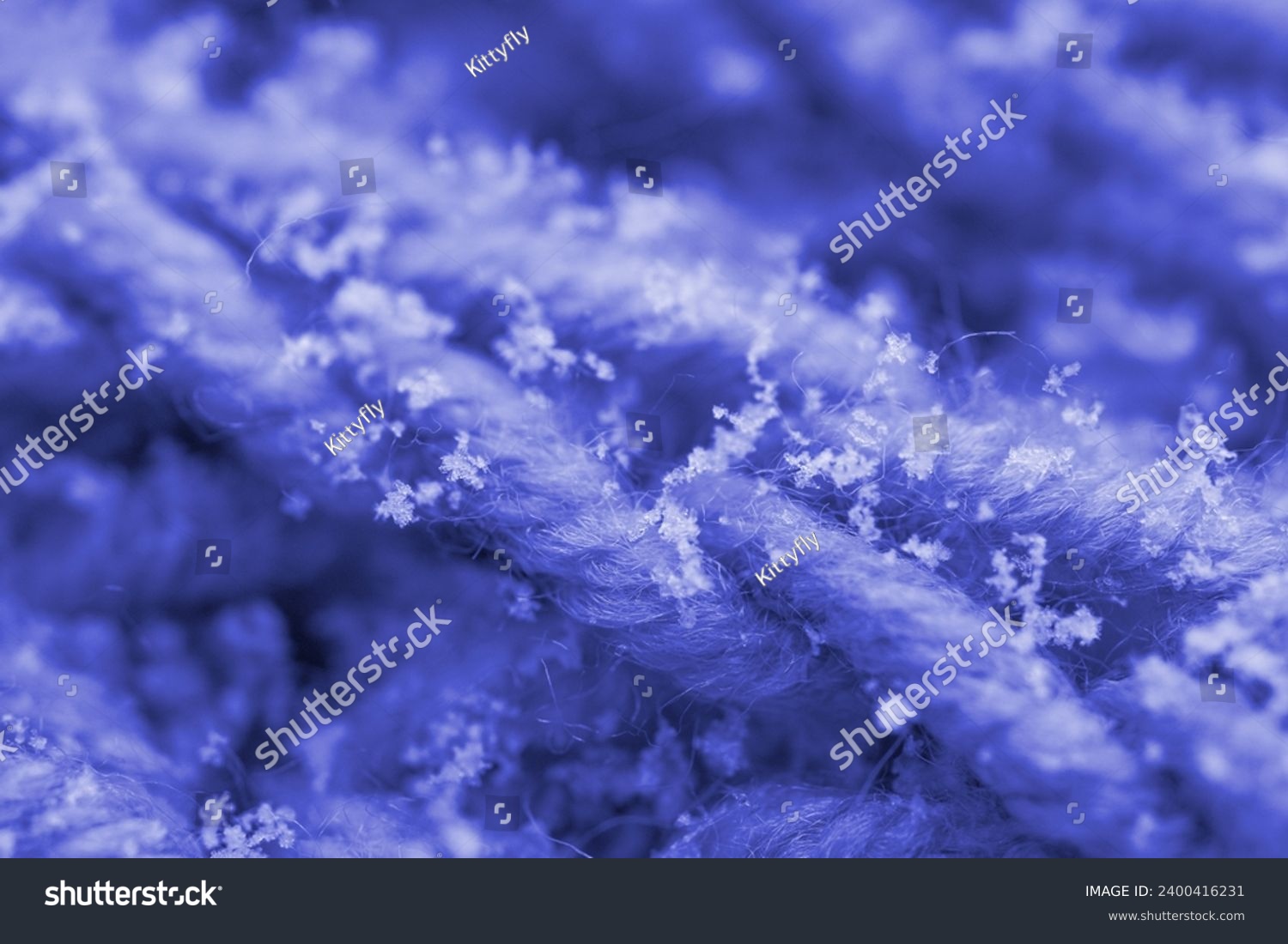Delicate white snowflakes gently descend onto woolen knitted background, macro detail, winter romance and meteorological phenomena, seasonal changes #2400416231