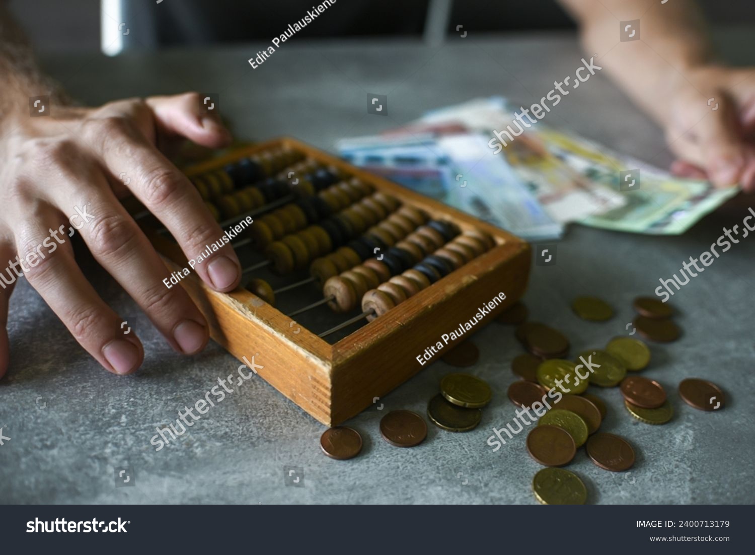 Man hands counting money with old vintage abacus #2400713179