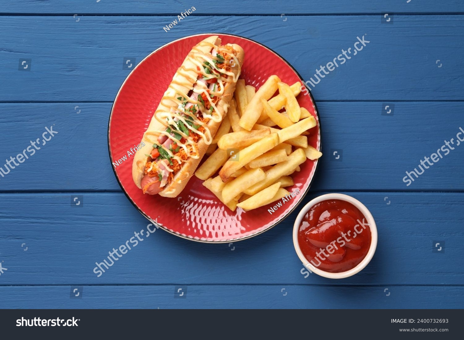 Delicious hot dog with bacon, carrot and parsley served on blue wooden table, flat lay #2400732693