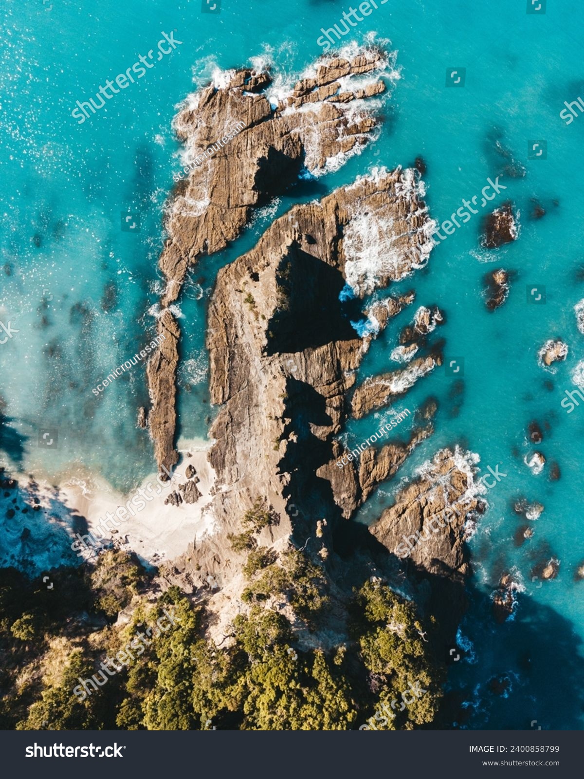 Vertical drone photo above ohope beach in New Zealand showing beaches, different rock formations, flora and fauna. #2400858799