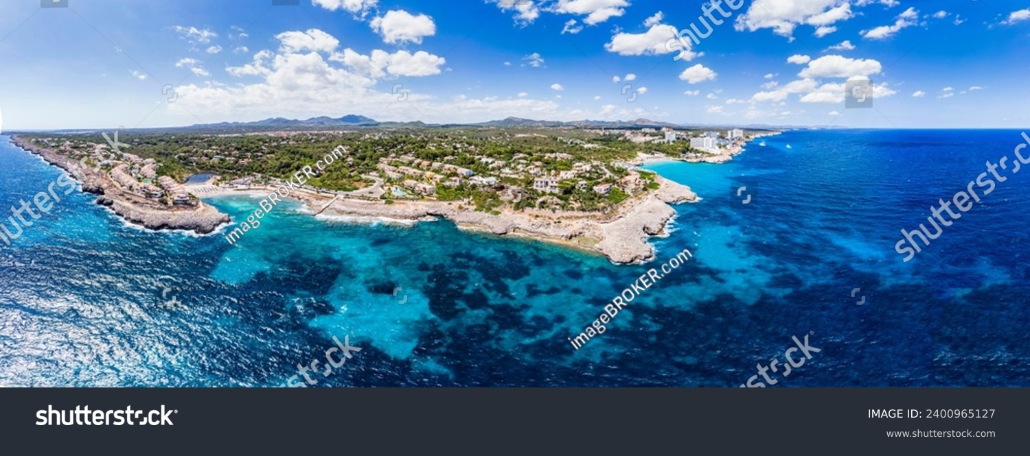 Drone shot, Rocky Coast with Villas and Hotels, Cala Tropicana and Cala Domingos, Porto Colom Region, Majorca, Balearic Islands, Spain #2400965127