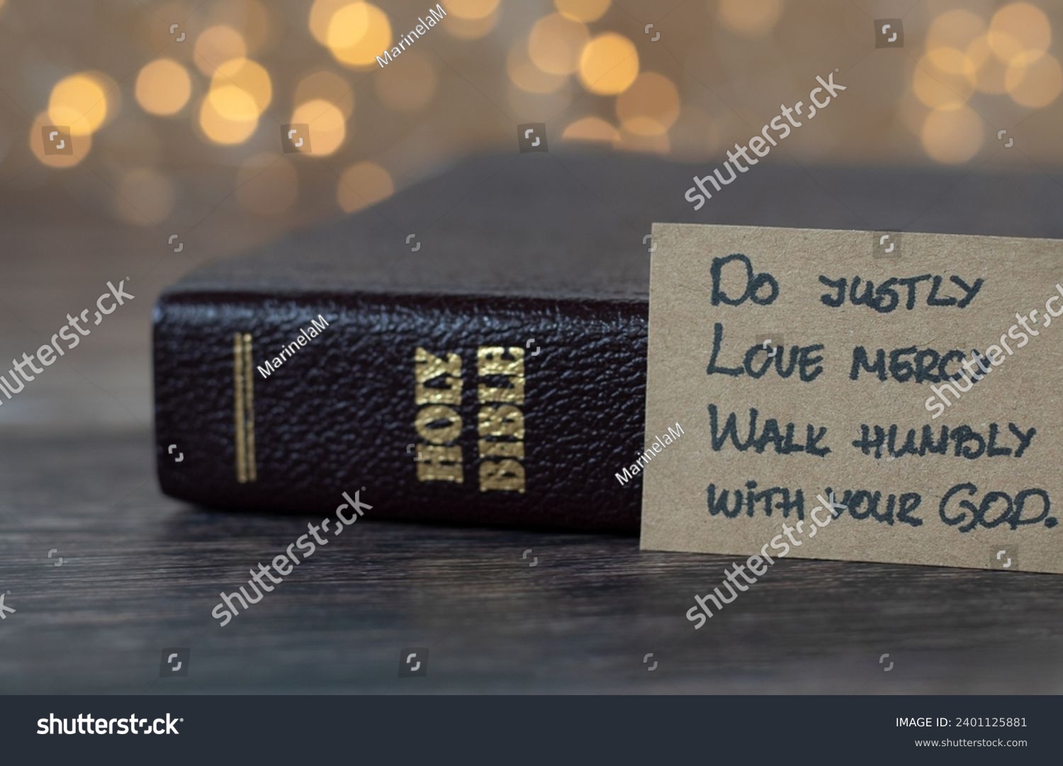 Do justly, love mercy, walk humbly with your God, handwritten biblical quote, Micah 6:8 and holy bible with bokeh background. Christian concept. #2401125881
