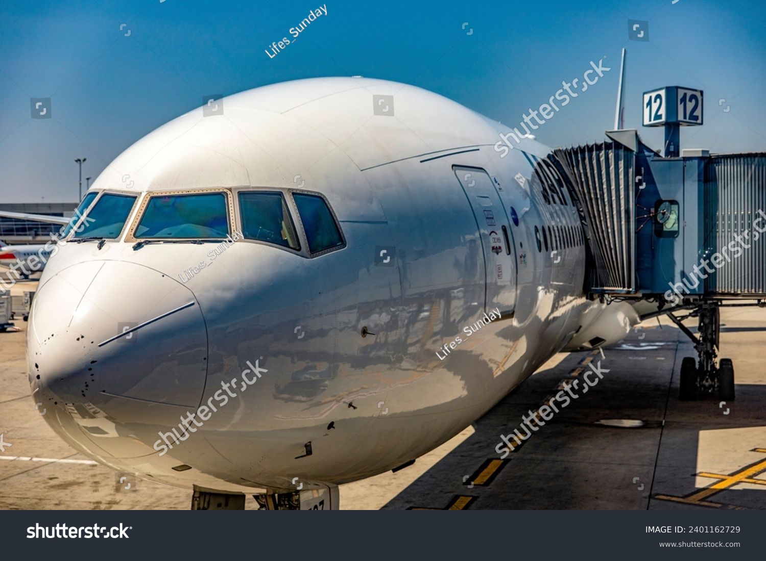 Beautiful image of an airline wide-body commercial jet parked at John F. Kennedy International Airport, where it is being loaded at gate 12 to begin a new journey on a new course. #2401162729