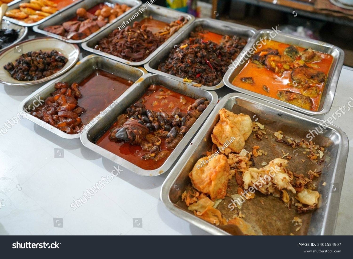 Tegal food stall (Warteg) or Padang food stall. Food stalls that provide various menus such as vegetables, chicken curry sauce, beef, eggs, tofu, tempeh. Asian or asia food.  #2401524907
