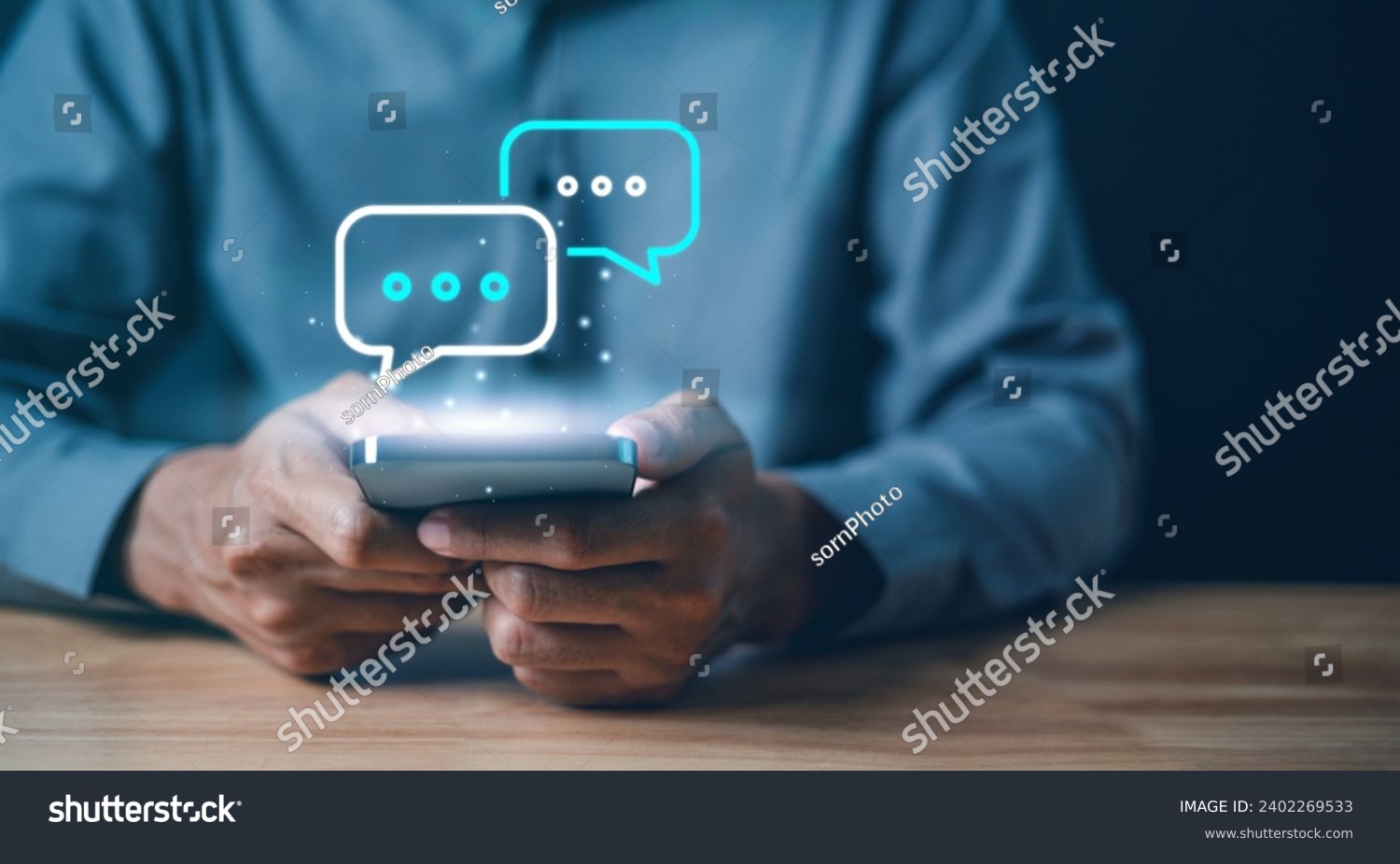 Technology, communication, Social media text messaging concepts, Businessman using smartphone texting message while sitting on table with in work office.	 #2402269533