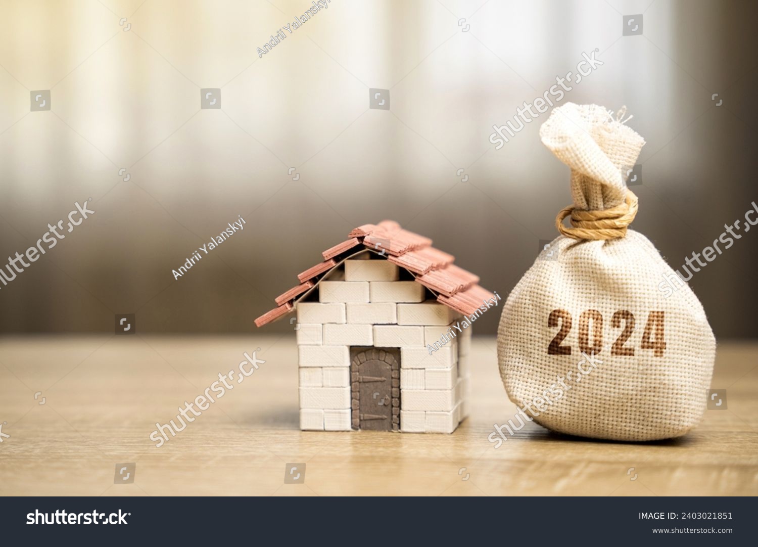 Money bag 2024 and miniature house. Family budget planning for next year. Mortgage rates and credit. Real estate fund concept. Refinance home. #2403021851