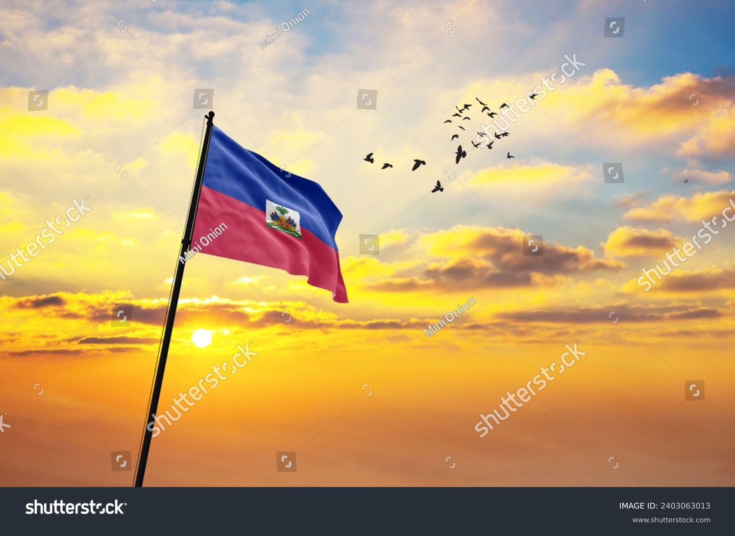 Waving flag of Haiti against the background of a sunset or sunrise. Haiti flag for Independence Day. The symbol of the state on wavy fabric. #2403063013