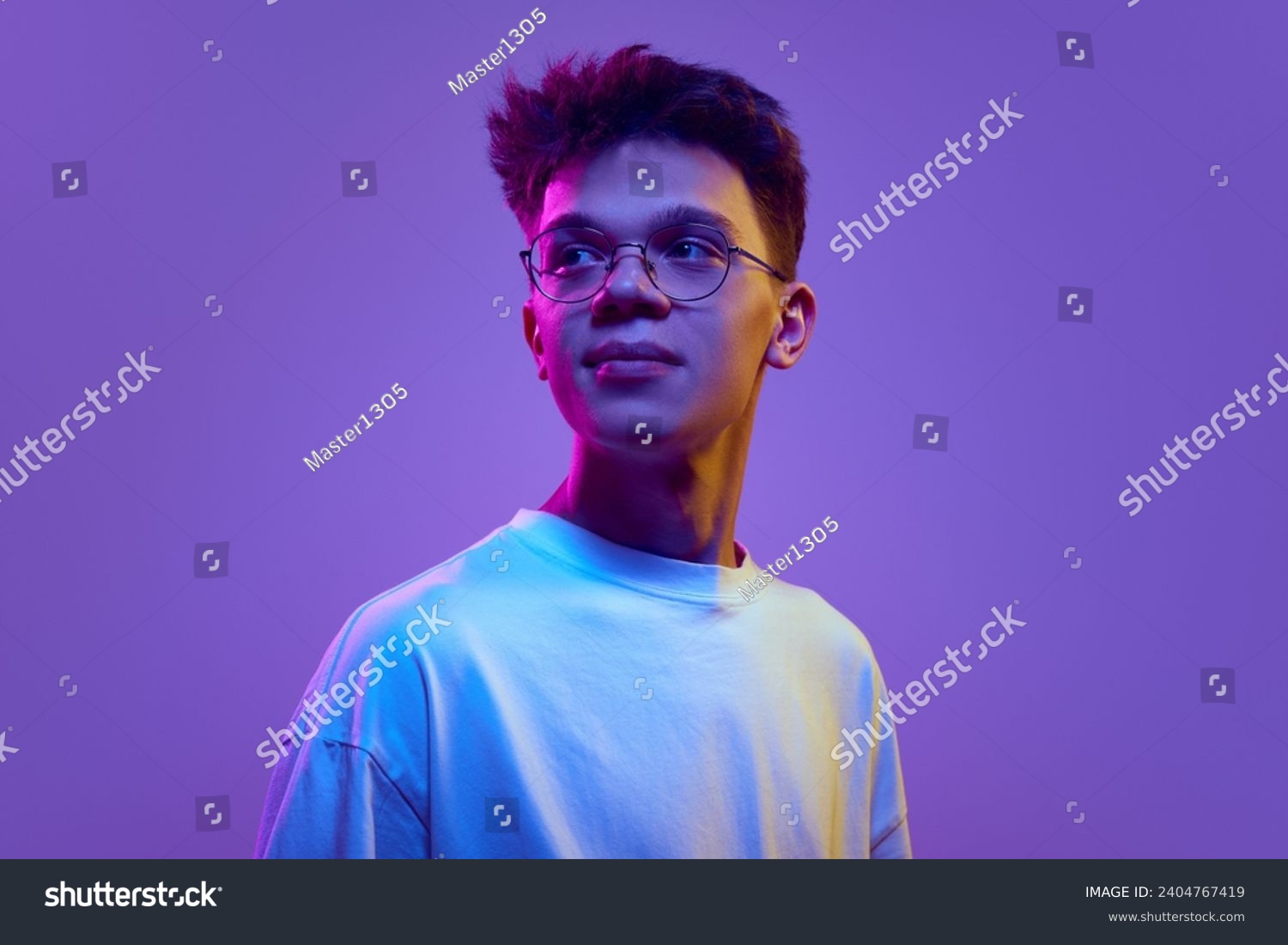 Portrait of smiling young man, boy in casual white t-shirt and sunglasses looking away against purple background in neon light. Relaxed look. Concept of human emotions, youth, education, lifestyle, ad #2404767419